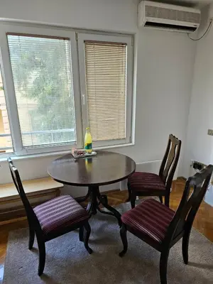 a dining room with a table and two chairs at Modern apartment - quiet street in Belgrade