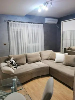 a living room with a couch and a window at Studio Lena in Belgrade