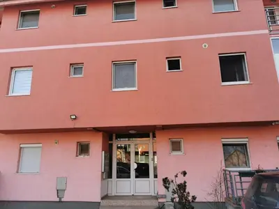 a red building with a white door at Studio Lena in Belgrade