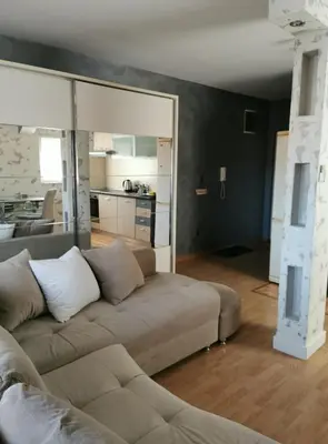 a living room with a couch and a kitchen at Studio Lena in Belgrade