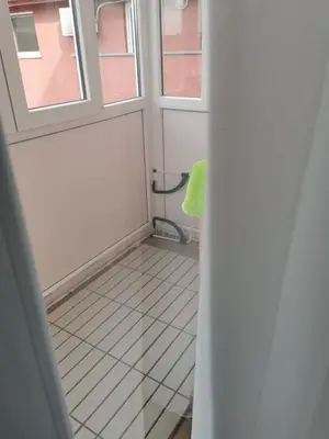 a small bathroom with a window and a white floor at Studio Lena in Belgrade