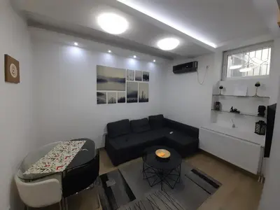 a living room with a couch and a table at XENIA1 in Belgrade
