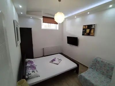 a small room with a bed and a chair at XENIA1 in Belgrade