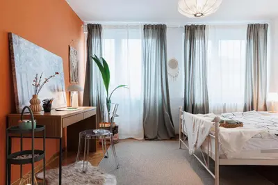 a bedroom with a bed and a desk and curtains at Sunny Apartments with Terrace & River View Old Town in Belgrade