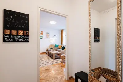 a hallway with a mirror and a living room at Sunny Apartments with Terrace & River View Old Town in Belgrade