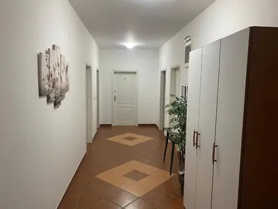 a hallway with white walls and a tile floor at Rooms Jajinci in Belgrade