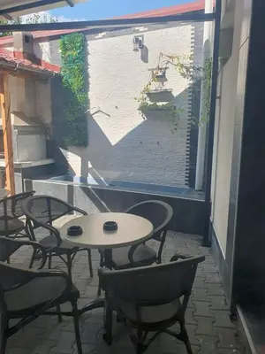 a patio with a table and chairs and a window at Lux apartment A5 at nice location in Pancevo in Pančevo