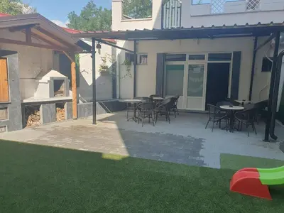 a patio with tables and chairs in a yard at Lux apartment A5 at nice location in Pancevo in Pančevo