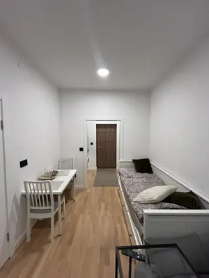 a room with a bed and a desk and a table at Nest in Sajmište