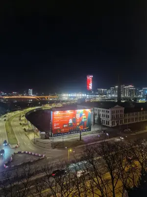 a view of a city at night with a building at Nest in Sajmište