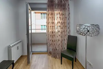a living room with a chair and a floor lamp at Apartment 32 in Belgrade