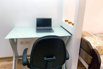 a desk with a laptop computer on top of it at Apartment 32 in Belgrade