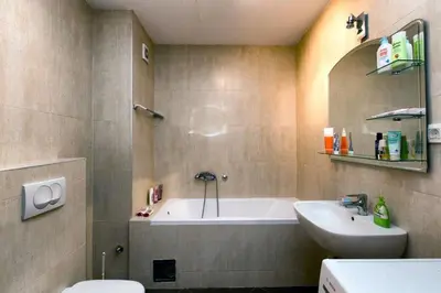 a bathroom with a tub and a sink and a toilet at Apartment 32 in Belgrade