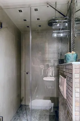 a person standing in a shower in a bathroom at Apartment 32 in Belgrade