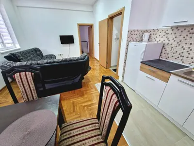 a living room with a couch and a table and chairs at Tami in Belgrade