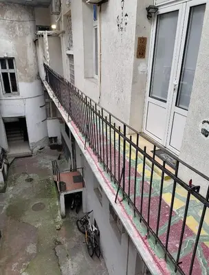 an old building with a staircase and a bike on the ground at Tsar Dušan Apartment in Belgrade