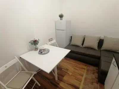 a living room with a couch and a table at Tsar Dušan Apartment in Belgrade