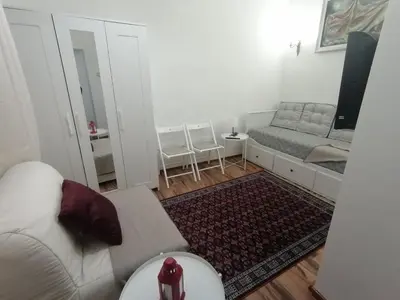 a living room with a couch and a bed at Tsar Dušan Apartment in Belgrade