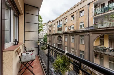 an apartment balcony with a view of buildings at ZIGZAG Belgrade in Belgrade