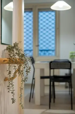 a room with a table and a chair and windows at ZIGZAG Belgrade in Belgrade