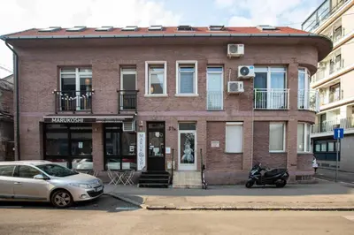 a brick building with a motorcycle parked in front of it at Downtown nest in Belgrade