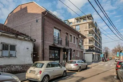 two cars parked on a street next to buildings at Downtown nest in Belgrade