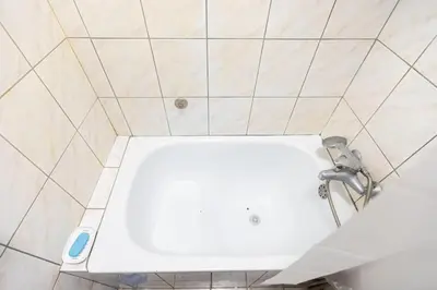 a white sink in a tiled bathroom at Downtown nest in Belgrade