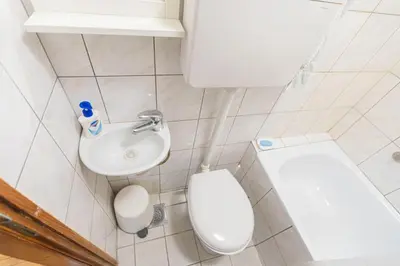 a small bathroom with a toilet and a sink at Downtown nest in Belgrade