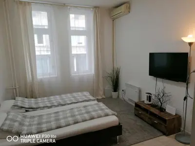 a bedroom with a bed and a flat screen tv at Nikolas 2 in Belgrade