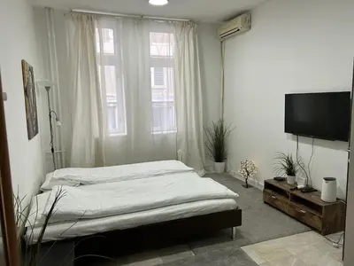 a bedroom with a bed and a flat screen tv at Nikolas 2 in Belgrade