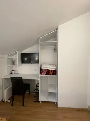 a room with a desk and a chair next to a wall at Apartments and Rooms L E F T RIVER Belgrade in Belgrade