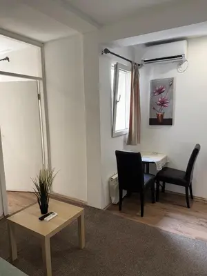 a living room with a table and two chairs at Apartments and Rooms L E F T RIVER Belgrade in Belgrade