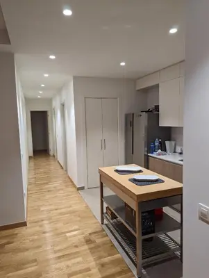 a kitchen with a table in the middle of a room at Belgrade Waterfront Victory Gardens in Sajmište