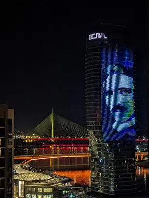 a building with a face painted on it at night at Belgrade Waterfront Victory Gardens in Sajmište