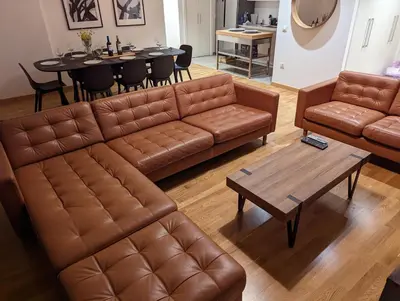 a living room with a couch and a table at Belgrade Waterfront Victory Gardens in Sajmište