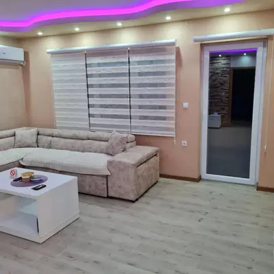 a living room with a couch and a table at Apartman Dalmacija in Ečka