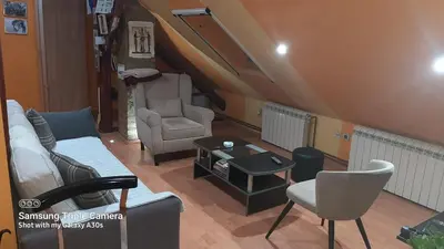 a living room with a couch and a table at Fly in Dobanovci