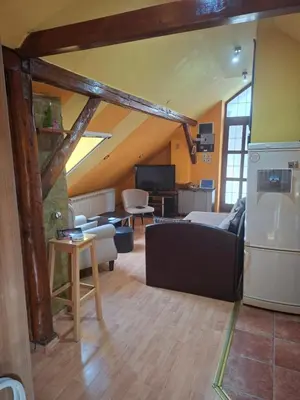 a living room with a couch and a kitchen at Fly in Dobanovci