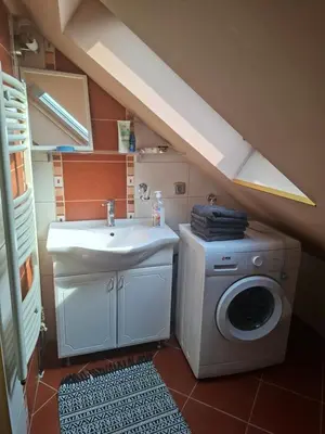 a bathroom with a washing machine and a sink at Fly in Dobanovci