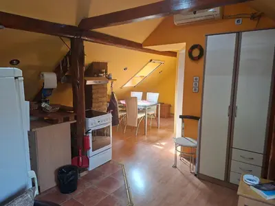 a kitchen and dining room with a stove and a table at Fly in Dobanovci