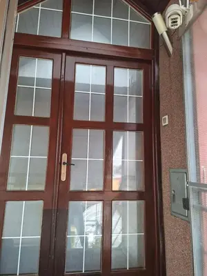 a wooden door with glass windows on a building at Fly in Dobanovci