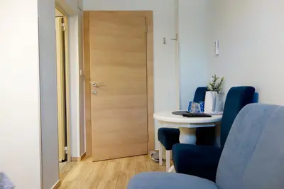 a room with a door and a table and chairs at Villa Loop Beograd in Belgrade