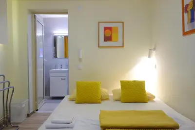 a room with a table with two yellow pillows at Villa Loop Beograd in Belgrade