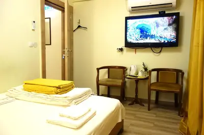 a room with a bed and a tv on the wall at Villa Loop Beograd in Belgrade