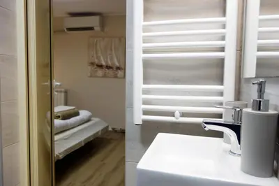 a bathroom with a sink and a toilet in a room at Villa Loop Beograd in Belgrade