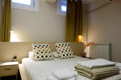 a bedroom with a bed with polka dots and pillows at Villa Loop Beograd in Belgrade