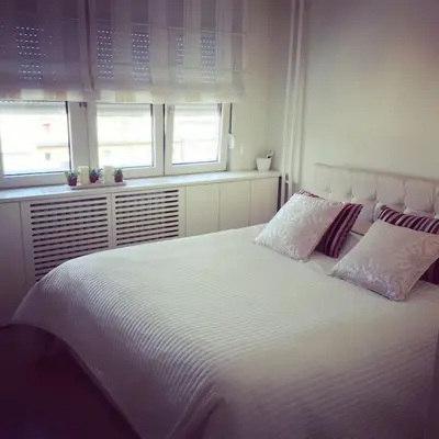 a bedroom with a large white bed with two pillows at Maya's Downtown Apartment in Belgrade