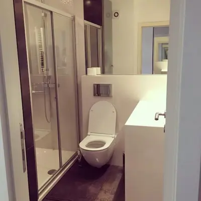 a bathroom with a toilet and a glass shower at Maya's Downtown Apartment in Belgrade
