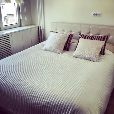 a large white bed with two pillows on it at Maya's Downtown Apartment in Belgrade