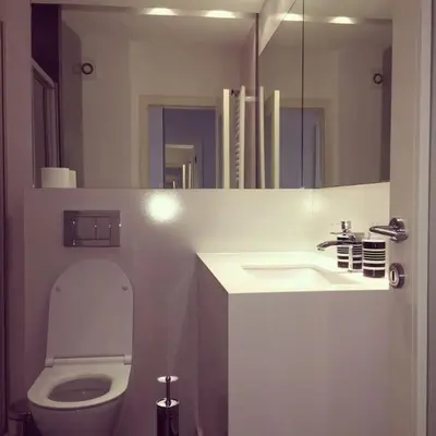 a bathroom with a toilet and a sink and a mirror at Maya's Downtown Apartment in Belgrade